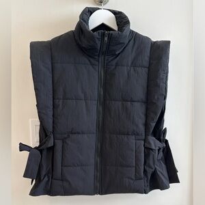 New!  Never worn Black puffy vest with side ties.  Size Small by Entro